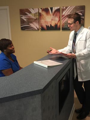 image of jonathan staman md at check in with an employee